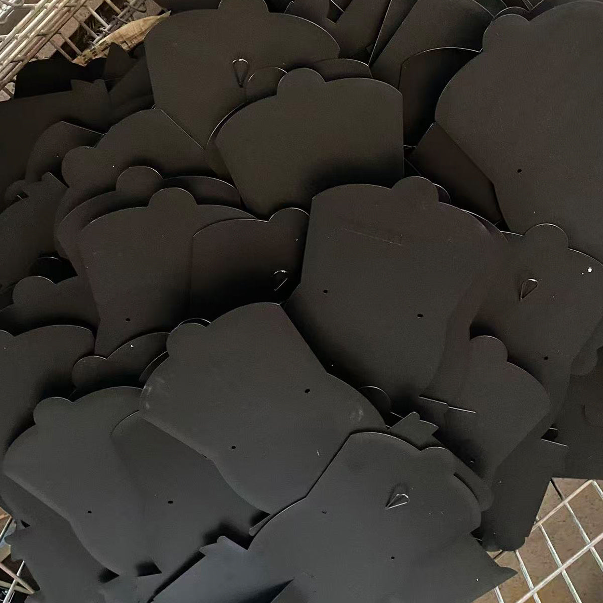 Large batch of finished black powder-coated metal parts