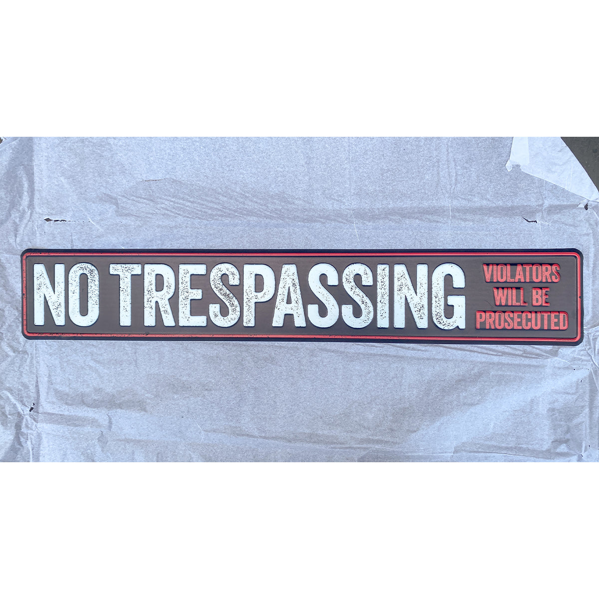 Finished custom metal no trespassing sign with distressed lettering