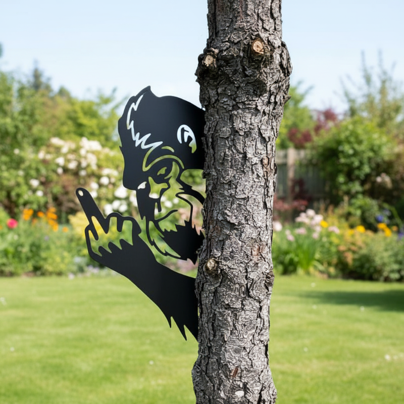 Humorous black metal gorilla tree decoration peeking around a tree trunk