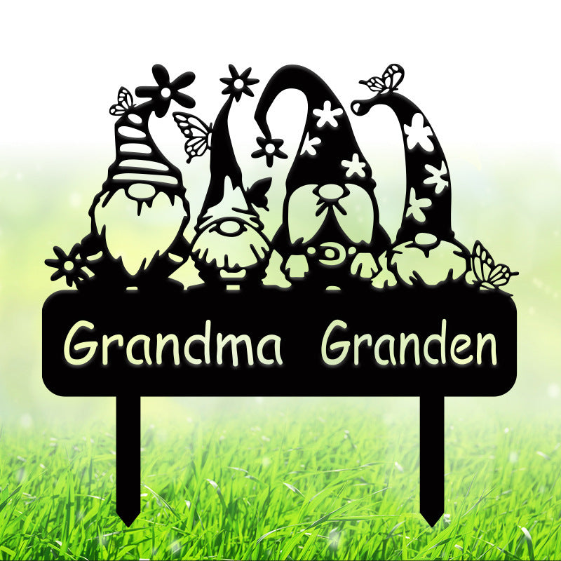 Black metal Grandma Garden stake with four decorative garden gnomes