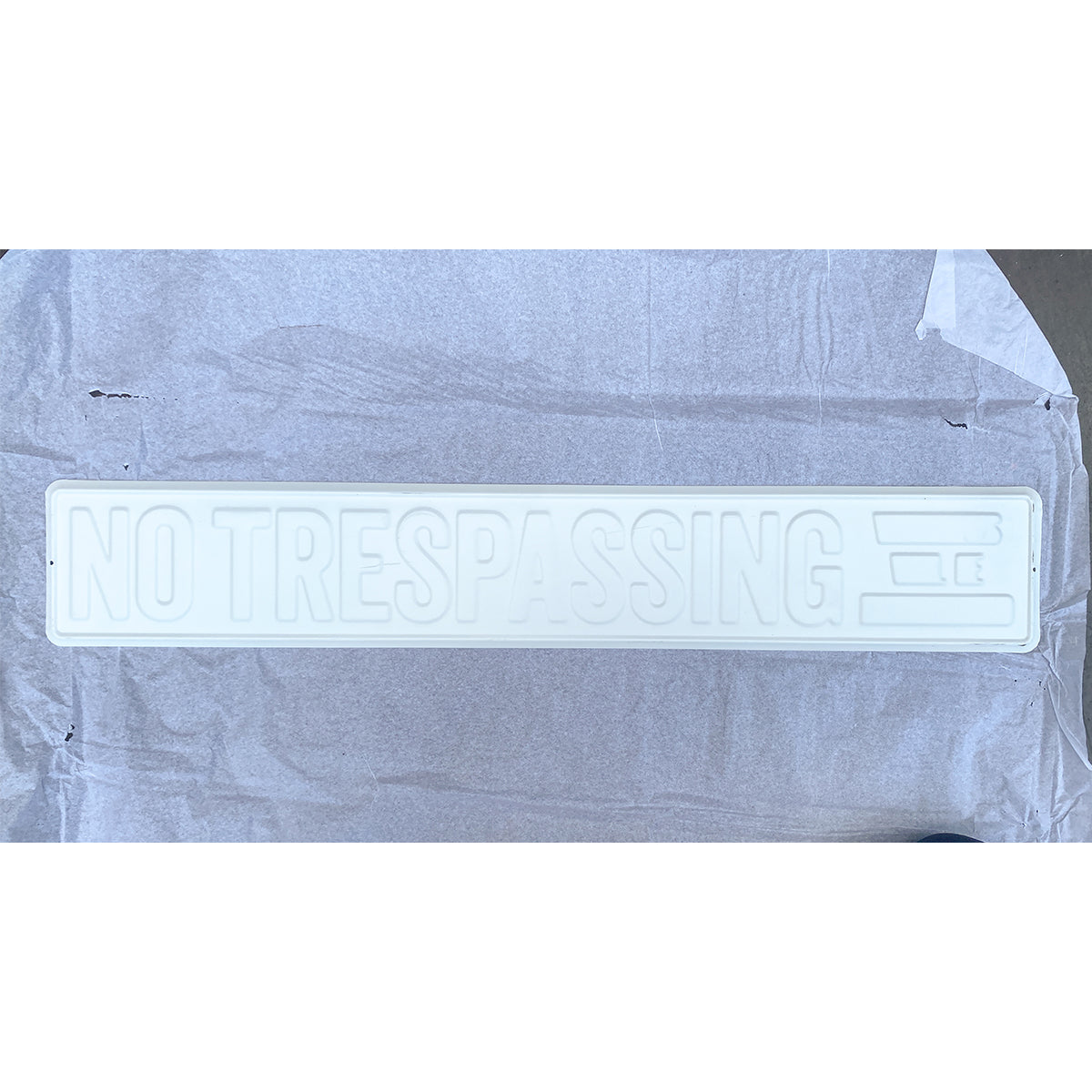 White base metal no trespassing sign before UV printing