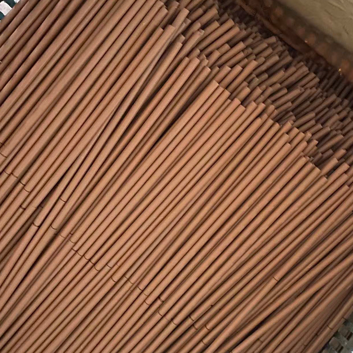 Bundle of metal hanging rods used on a powder coating production line
