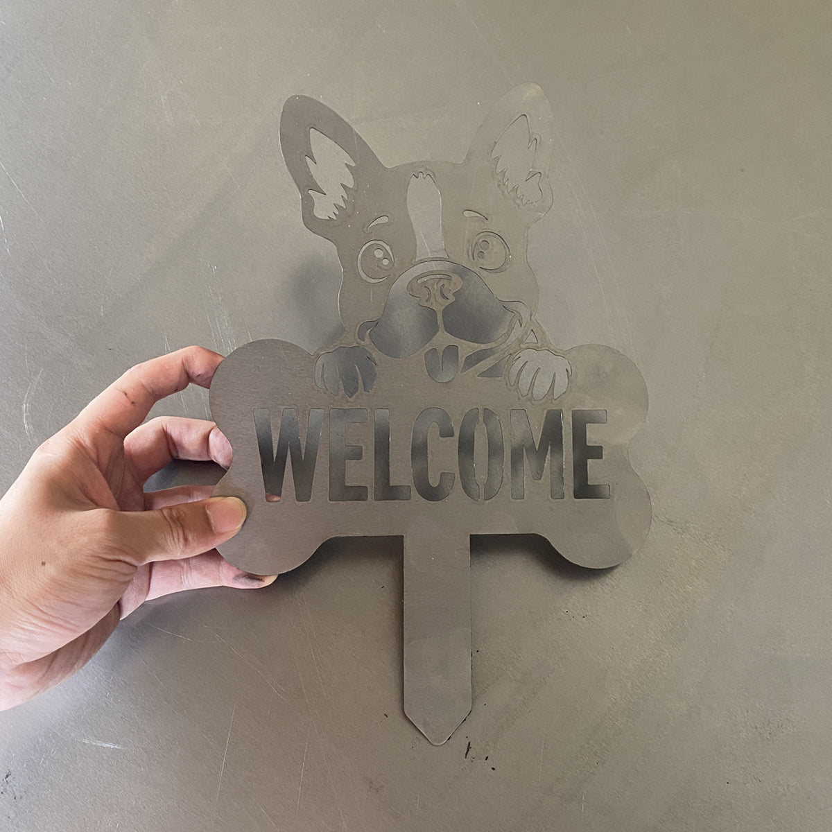 Unfinished laser-cut metal dog welcome garden stake prototype