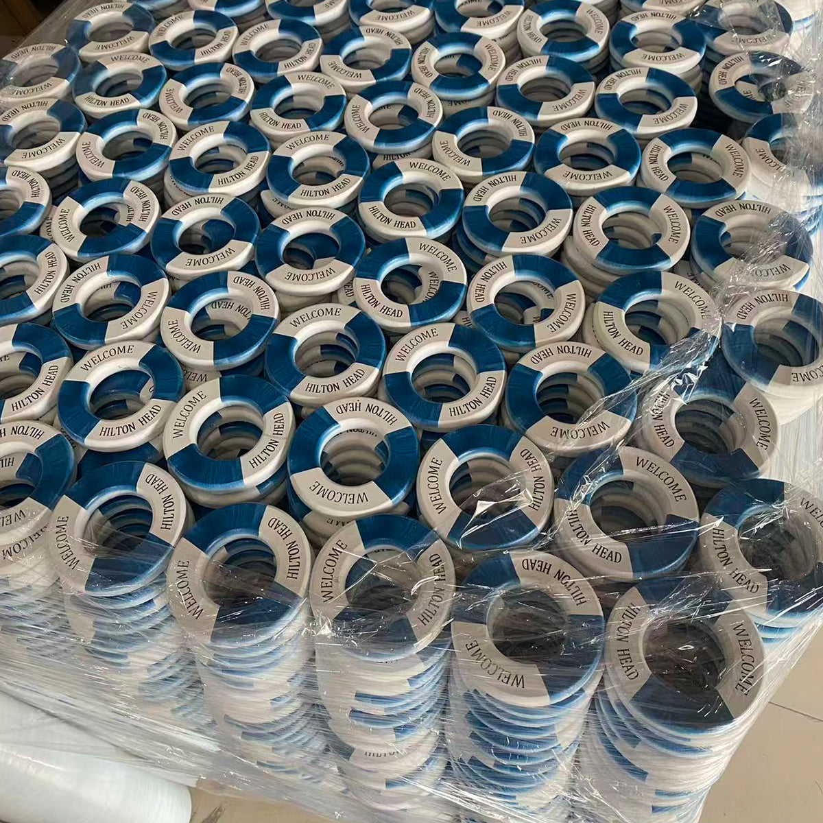 Large batch of blue and white UV-printed Hilton Head lifebuoy decorations