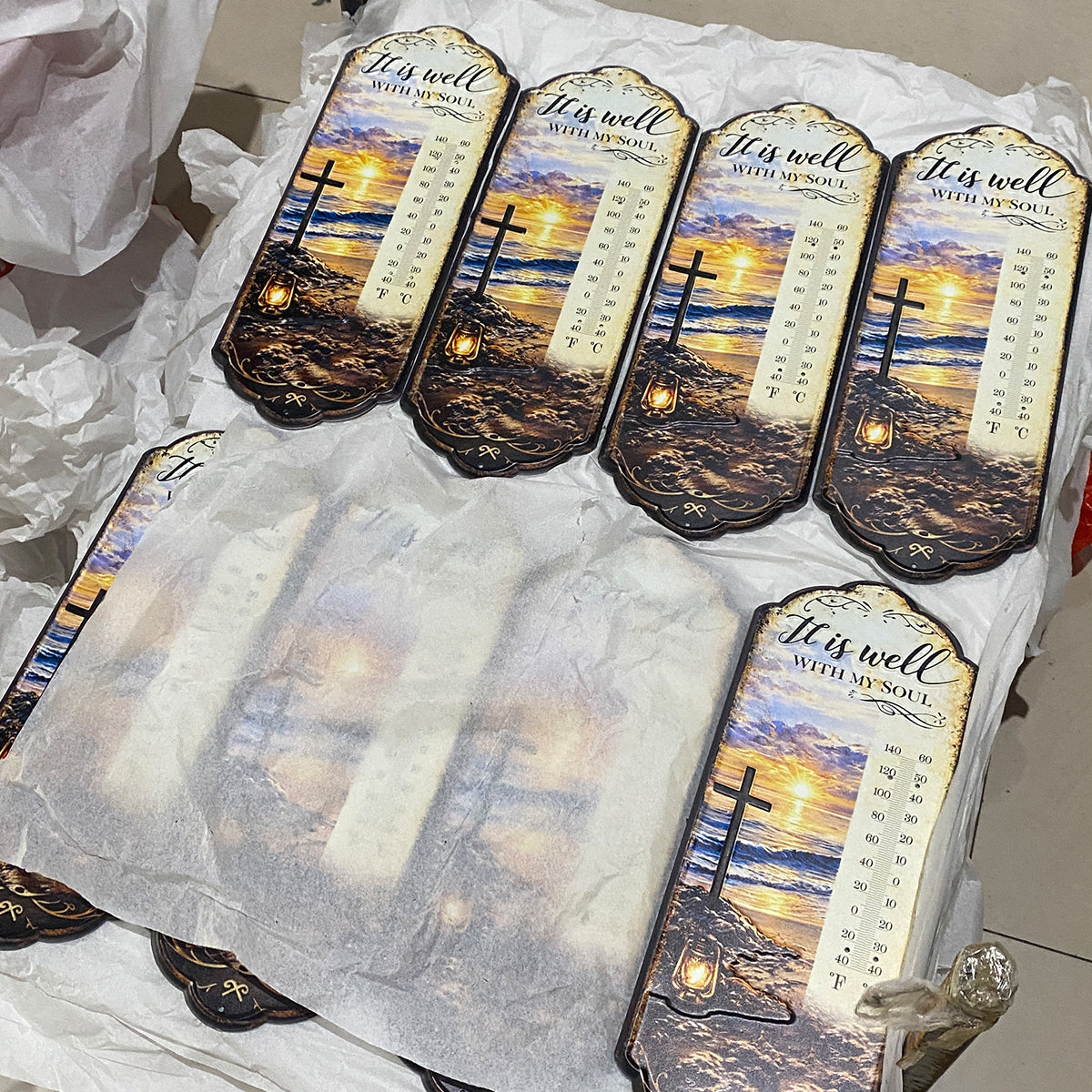 Batch of UV-printed religious wall thermometers with a cross and sunset design